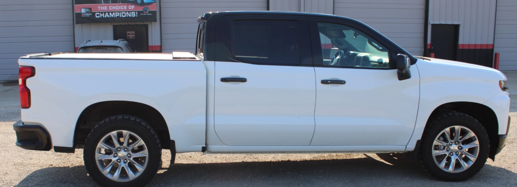 White pickup truck featuring a custom black and white tuxedo vinyl wrap installed by Pro DeZigns in Columbia Missouri.